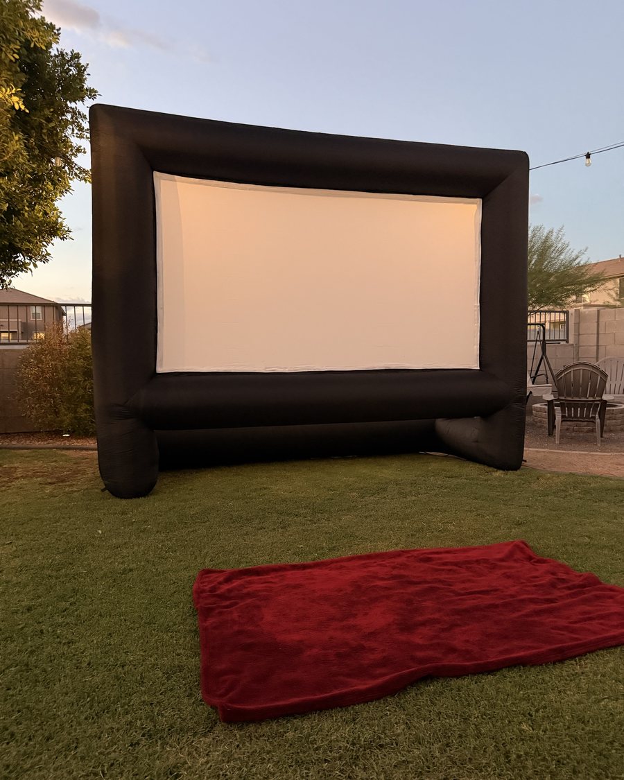 16-foot inflatable movie screen set up in a backyard at dusk in Surprise, Arizona